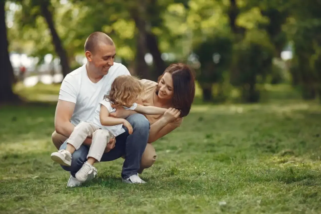 Parents and child playing together outdoors