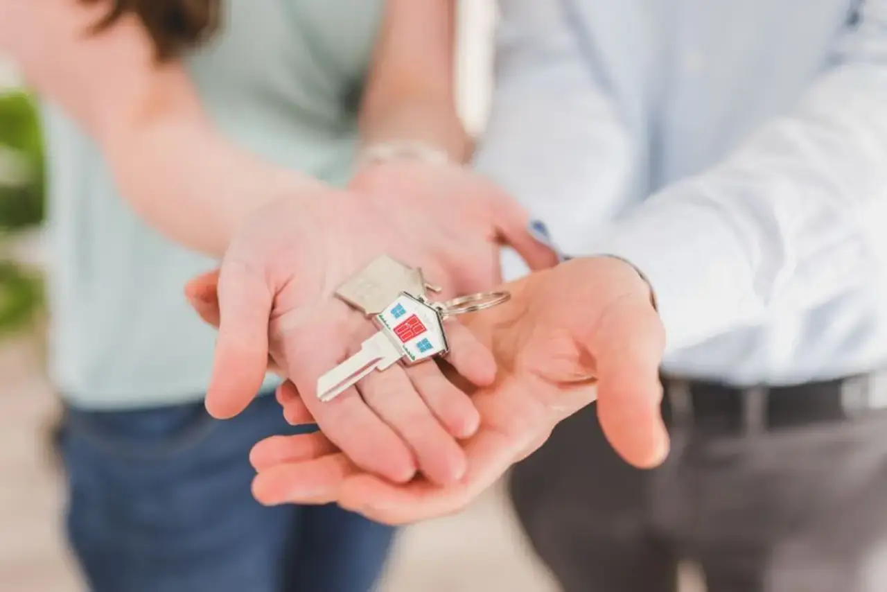 Exchanging house keys representing a financial agreement